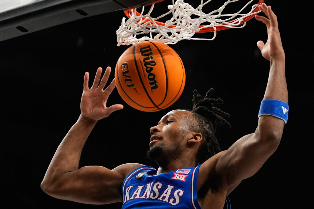 FILE - Kansas' Darryn Peterson dunks during the first half of an NCAA college basketball game against Houston in the semifinal round of the Big 12 Conference tournament March 13, 2026, in Kansas City, Mo. (AP Photo/Charlie Riedel, File)