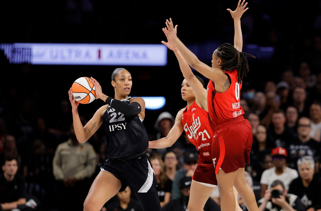 Las Vegas Aces center A'ja Wilson (22) is pressured by Indiana Fever forward Makayla Timpson (21) and guard Kelsey Mitchell (0) during the first half in Game 3 of an WNBA basketball first-round playoff series Thursday, Oct.1, 2026, in Las Vegas. (AP Photo/Steve Marcus)