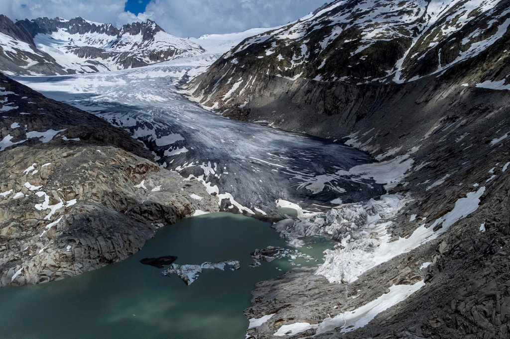 FILE - A lake of meltwater has formed on the tongue of the Rhone glacier near Goms, Switzerland, June 13, 2023. (AP Photo/Matthias Schrader, File)