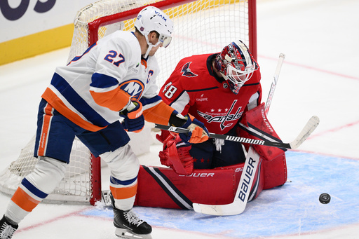 Washington Capitals goaltender Logan Thompson (48) and New York Islanders left wing Anders Lee (27) battle for the puck during the second period of an NHL hockey game, Friday, Oct. 31, 2025, in Washington. (AP Photo/Nick Wass) Washington Capitals goaltender Logan Thompson (48) and New York Islanders left wing Anders Lee (27) battle for the puck during the second period of an NHL hockey game, Friday, Oct. 31, 2025, in Washington. (AP Photo/Nick Wass)