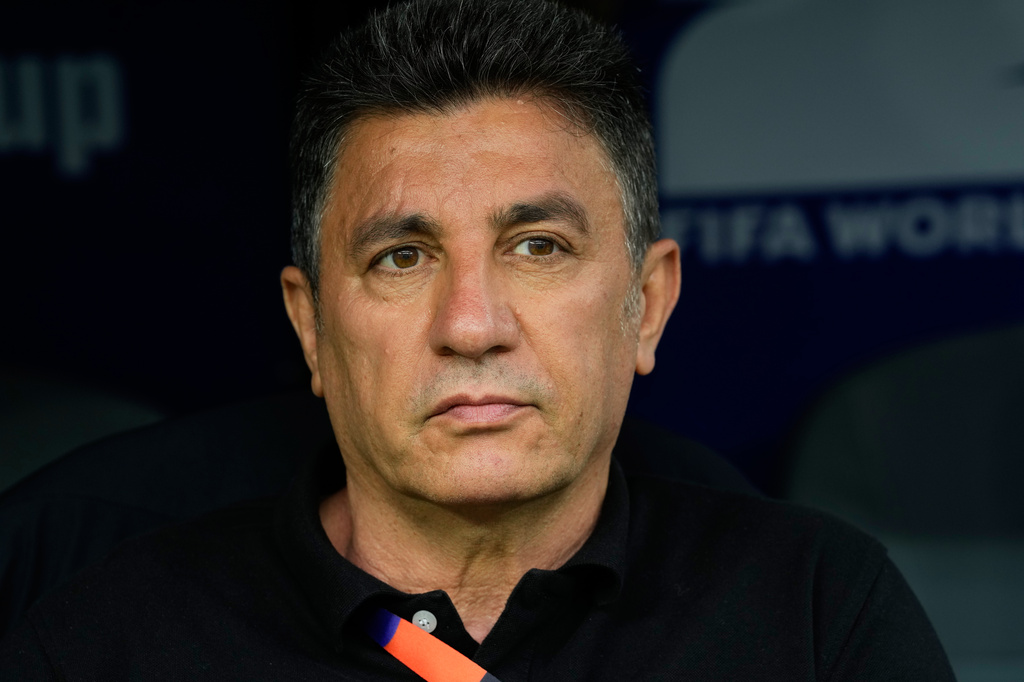 Iran head coach Amir Ghalehnoy sits on the bench prior to the World Cup Group G soccer match between Belgium and Iran in Inglewood, Calif., near Los Angeles, Sunday, June 21, 2026. (AP Photo/Andre Penner)