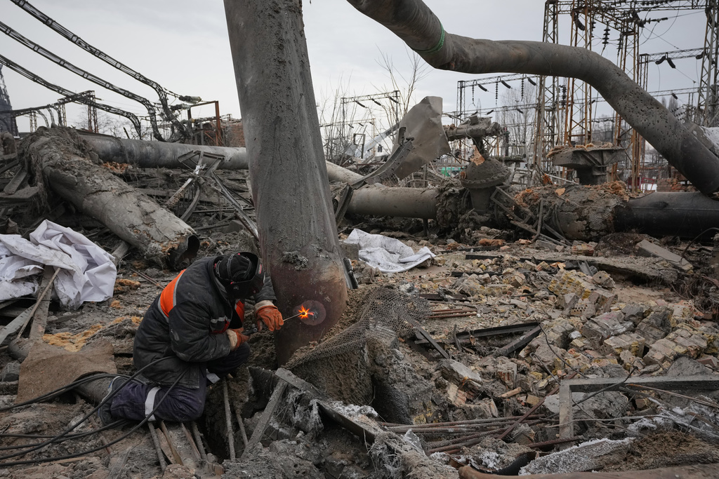 Workers clean up damage at Darnytsia Thermal Power Plant after a Russian attack in Kyiv, Ukraine, Wednesday, Feb. 4, 2026. (AP Photo/Sergei Grits)