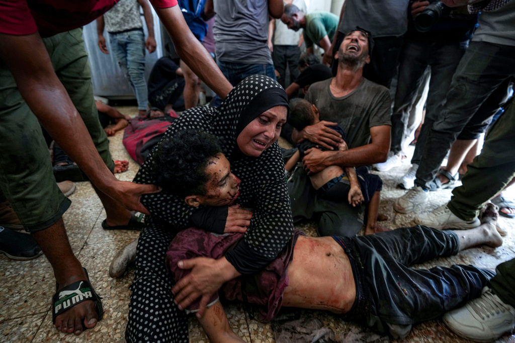 Faten Mreish holds her son's body at a hospital morgue in Deir al-Balah, Gaza Strip, Aug. 28, 2024, after he and others were killed in an Israeli bombardment. (AP Photo/Abdel Kareem Hana)