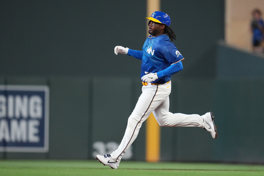 Minnesota Twins' Josh Bell runs to second base after hitting an RBI double during the sixth inning of a baseball game against the Kansas City Royals, Friday, June 5, 2026, in Minneapolis. (AP Photo/Abbie Parr)