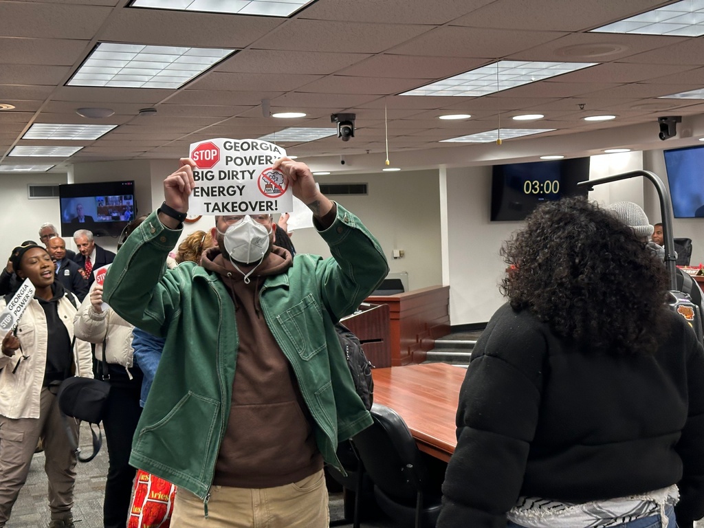 \Protestors are escorted out of a Georgia Public Service Commission meeting on Friday, Dec. 19, 2025 in Atlanta. (AP Photo/Jeff Amy)