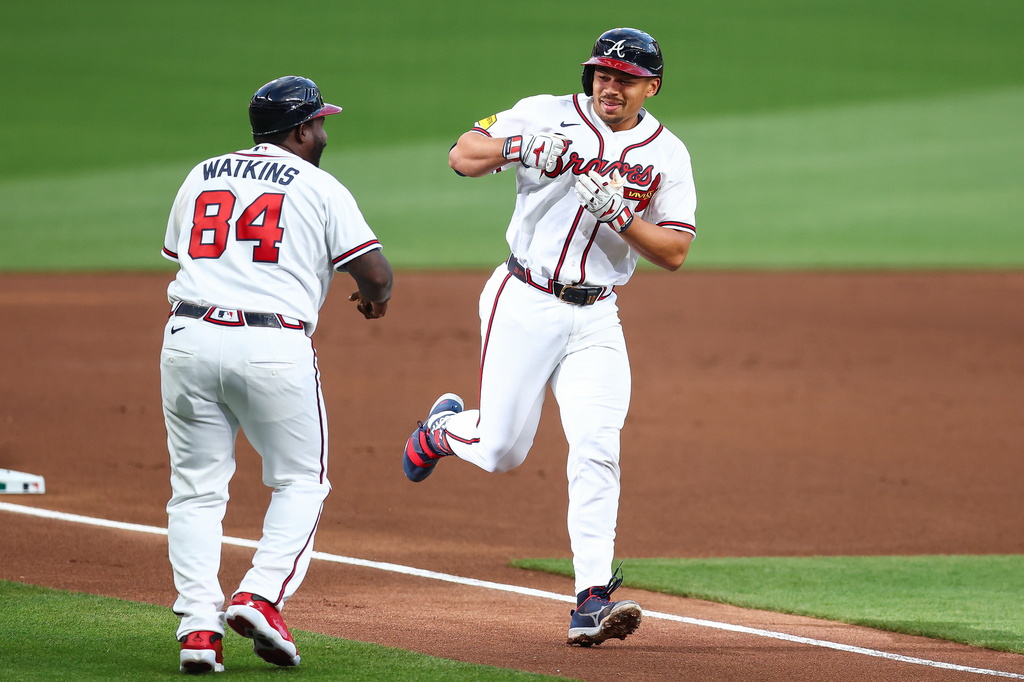 Atlanta Braves' Drake Baldwin, right, reacts with third base coach Tommy Watkins (84) after hitting a solo home run in the first inning of a baseball game against the Athletics, Tuesday, March 31, 2026, in Atlanta. (AP Photo/Colin Hubbard)
