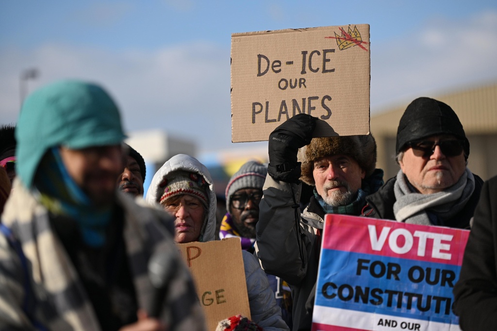 Protesters gather at a rally for immigrants and workers outside Signature Aviation near the Minneapolis–Saint Paul International Airport, Wednesday, Dec 3, 2025, in Minneapolis. (AP Photo/Tom Baker)