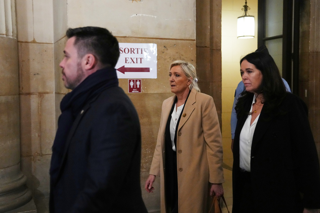 Far-right leader Marine Le Pen, center, arrives for her appeal trial, in Paris, France, Wednesday, Feb. 11, 2026. (AP Photo/Aurelien Morissard)