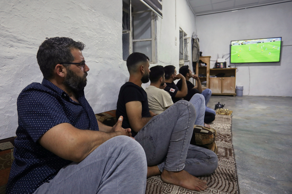 A small group of Yazidis gather to watch the Germany-Ecuador match at the home of community leader Ismail Dalaf in Khirbet al-Ghazal, northeastern Syria, late Thursday, June 25, 2026.(AP Photo/Hogir Al Abdo)