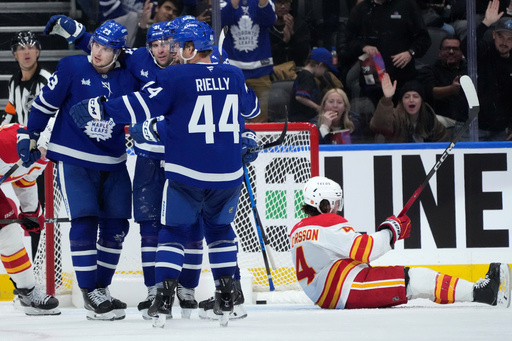 Toronto Maple Leafs forward Matthew Knies (23) celebrates his goal with teammates during third period NHL hockey action against the Calgary Flames, in Toronto, Tuesday, Oct. 28, 2025. (Nathan Denette/The Canadian Press via AP) Toronto Maple Leafs forward Matthew Knies (23) celebrates his goal with teammates during third period NHL hockey action against the Calgary Flames, in Toronto, Tuesday, Oct. 28, 2025. (Nathan Denette/The Canadian Press via AP)