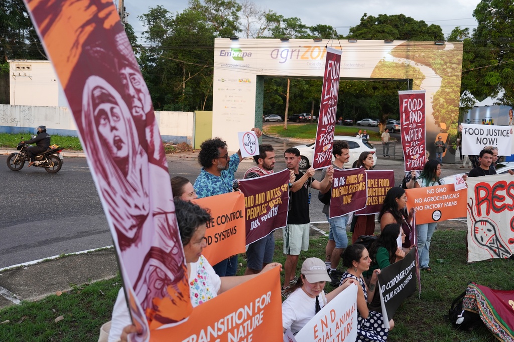 Demonstrators protest against big agribusiness near the agriZONE during the COP30 U.N. Climate Summit, Monday, Nov. 10, 2025, in Belem, Brazil. (AP Photo/Joshua A. Bickel)