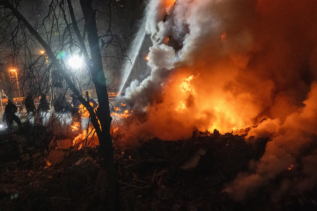 Firefighters put out the fire in an multi-storey apartment building following a Russian missile attack in Kharkiv, Ukraine, Saturday, March 7, 2026. (AP Photo/Andrii Marienko)