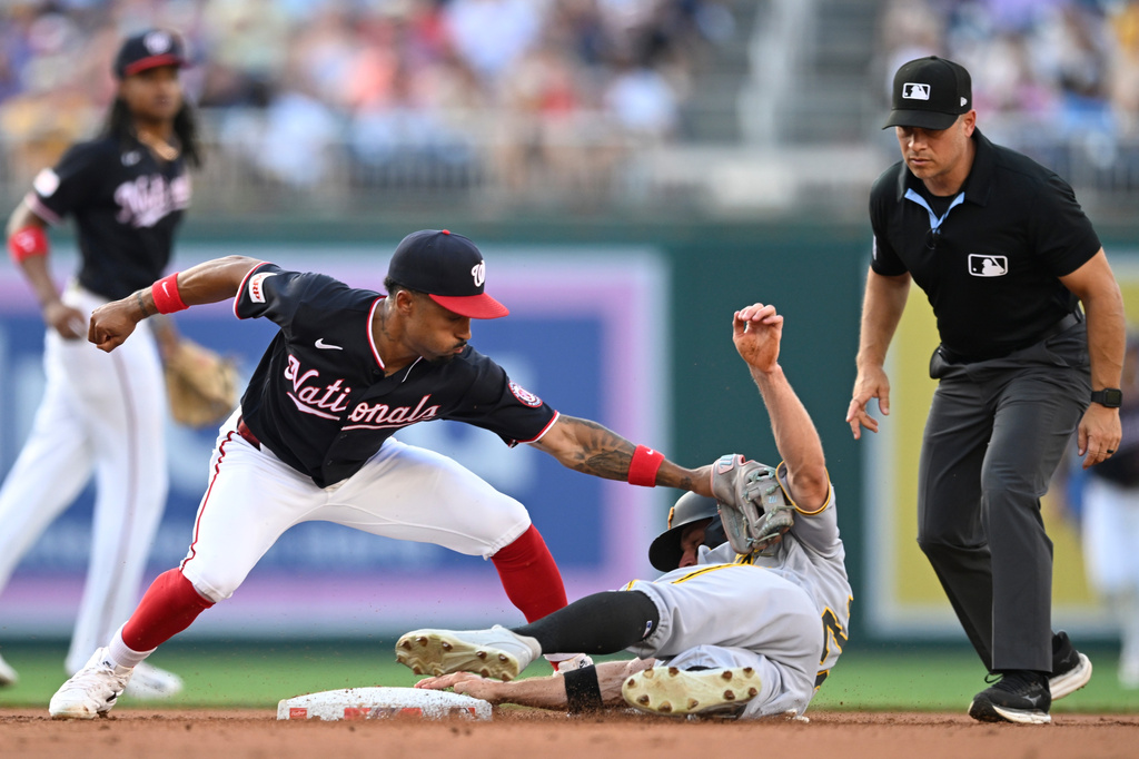 Washington Nationals second baseman Nasim Nuñez, front left, is late with the tag as Pittsburgh Pirates' Jake Mangum, second from right, steals second during the second inning of a baseball game, Friday, July 3, 2026, in Washington. (AP Photo/John McDonnell)