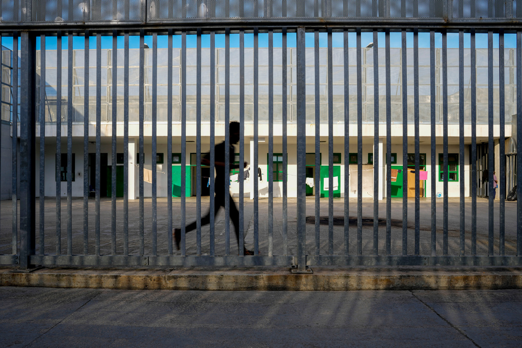 FILE - A detainee runs in an open area of the Ponte Galeria, one of the facilities created to hold migrants ahead of their repatriation, in Rome, Italy, March 19, 2024. (AP Photo/Andrew Medichini, File)