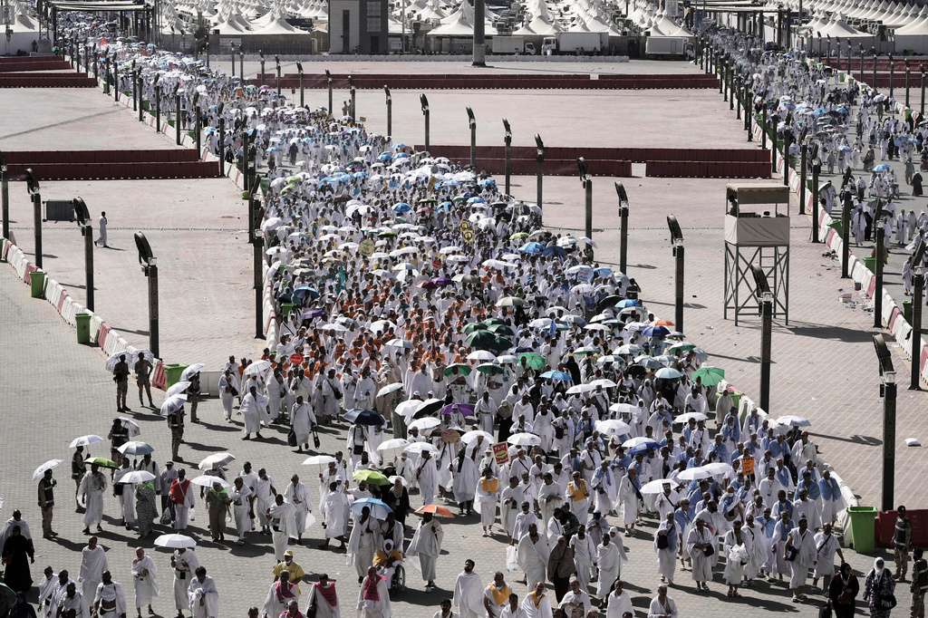 FILE - Muslim pilgrims go to cast stones at pillars in the symbolic stoning of the devil, the last rite of the annual Hajj, in Mina near the holy city of Mecca, Saudi Arabia, June 6, 2025. (AP Photo/Amr Nabil, File)