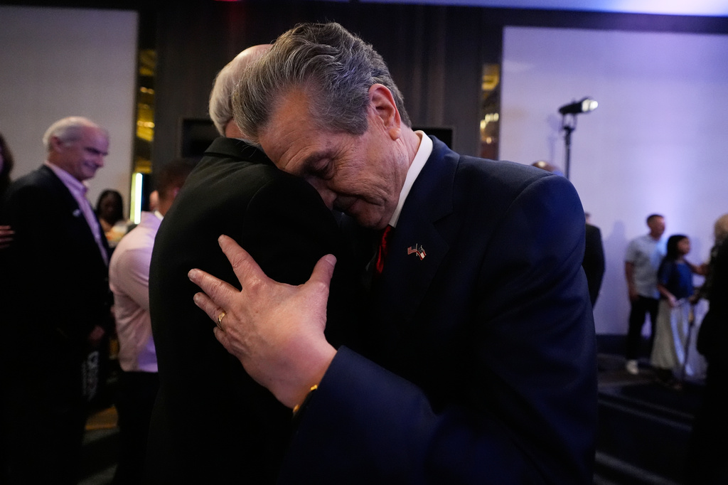 Georgia gubernatorial candidate Rick Jackson is hugged by a supporter after speaking during a primary election night party on Tuesday, May 19, 2026, in Atlanta. (AP Photo/Brynn Anderson)