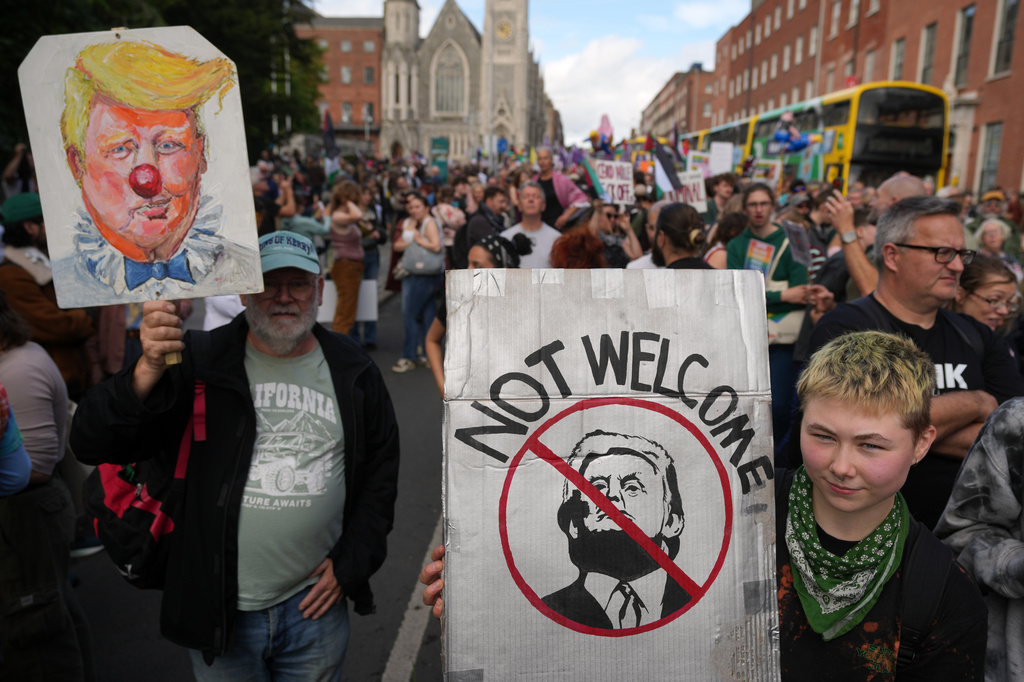 Protesters show placards during a demonstration against the visit of U.S. President Donald Trump in Dublin, Saturday, Sept. 12, 2026.(AP Photo/Kin Cheung)