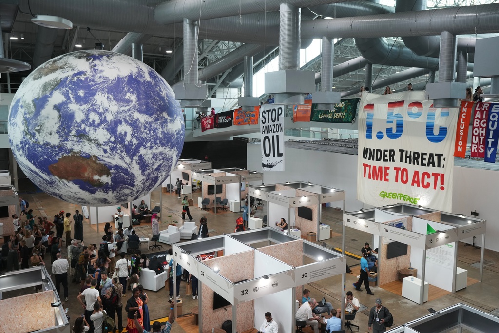 Activists hang banners while participating in a demonstration at the COP30 U.N. Climate Summit, Friday, Nov. 21, 2025, in Belem, Brazil. (AP Photo/Andre Penner)