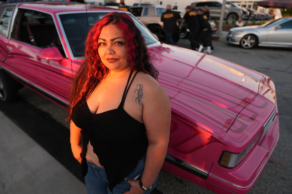 Amber, a low rider, poses for a portrait at the 6th Annual Lady Lowrider Cruise Night in celebration of International Women's Day in Pasadena, Calif., on Sunday, March 8, 2026. (AP Photo/Damian Dovarganes)