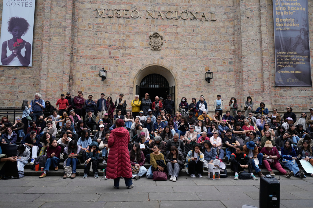 University students hold a class outdoors in front of the National Museum as part of a protest against the removal of some artworks from the museum in Bogota, Colombia, Wednesday, Oct. 21, 2026. (AP Photo/Fernando Vergara)