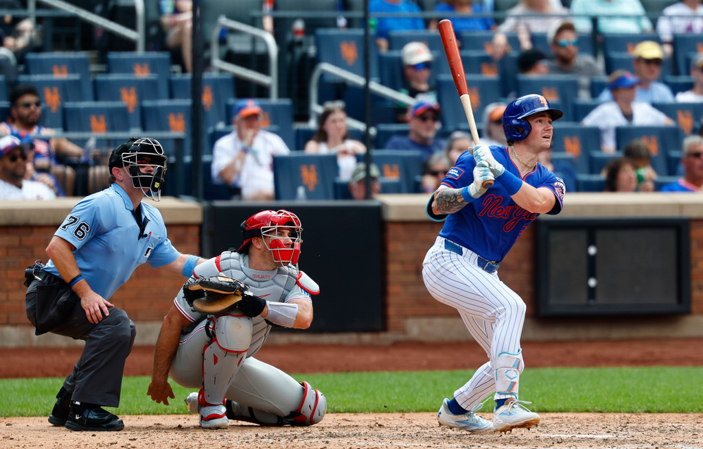New York Mets' A.J. Ewing, right, watches his two-run home run against the Philadelphia Phillies during the sixth inning of a baseball game, Sunday, June 28, 2026, in New York. (AP Photo/Noah K. Murray)