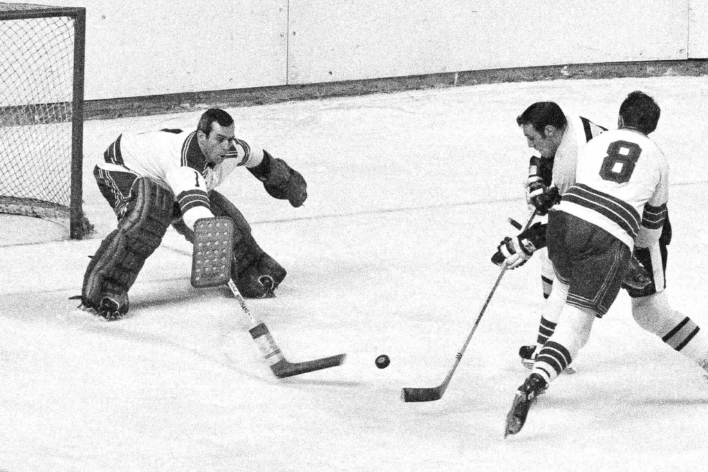 FILE - Boston Bruins' Phil Esposito fires a shot by New York Rangers' goalie Ed Giacomin in second period of their game at Boston Garden, March 1, 1969. AP Photo/A.E. Maloof, File)
