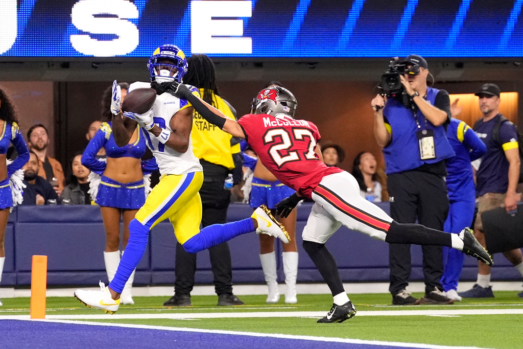 Los Angeles Rams wide receiver Davante Adams makes a catch to score a touchdown against Tampa Bay Buccaneers cornerback Zyon McCollum (27) during the first half of an NFL football game, Sunday, Nov. 23, 2025, in Inglewood, Calif. (AP Photo/Mark J. Terrill)