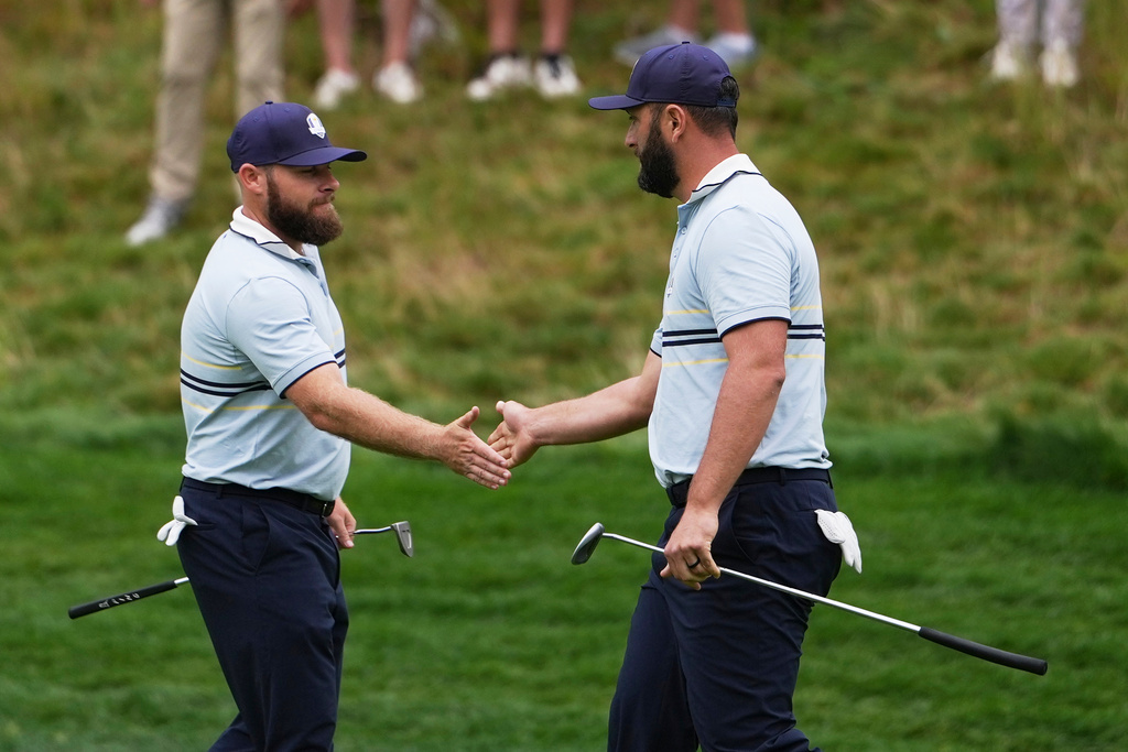 Europe's Jon Rahm and Tyrrell Hatton celebrate on the eighth hole at Bethpage Black golf course during the Ryder Cup golf tournament, Friday, Sept. 26, 2025, in Farmingdale, N.Y. (AP Photo/Matt Slocum)