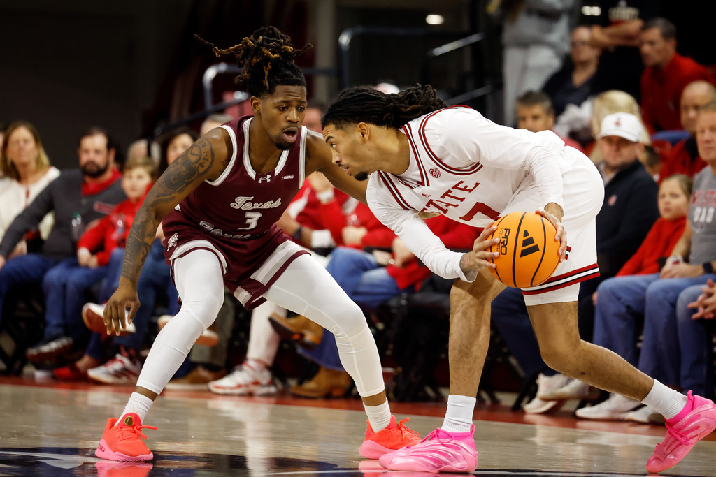 North Carolina State's Alyn Breed, right, tries to move the ball around Texas Southern's Bryce Roberts (3) during the first half of an NCAA college basketball game in Raleigh, N.C., Wednesday, Dec. 17, 2025. (AP Photo/Karl DeBlaker)
