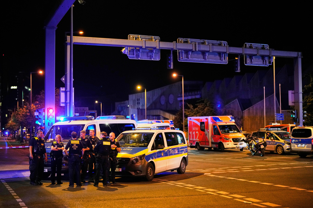 Emergency personnel and police gather in Berlin, early Sunday, July 26, 2026, following the cancellation of Christopher Street Day festivities. (AP Photo/Ebrahim Noroozi)