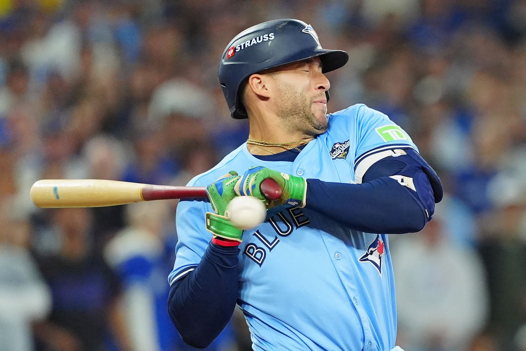 Toronto Blue Jays' George Springer (4) gets out of the way of a high inside pitch during the eighth inning in Game 6 of baseball's World Series against the Los Angeles Dodgers in Toronto on Friday, Oct. 31, 2025. (Frank Gunn/The Canadian Press via AP)