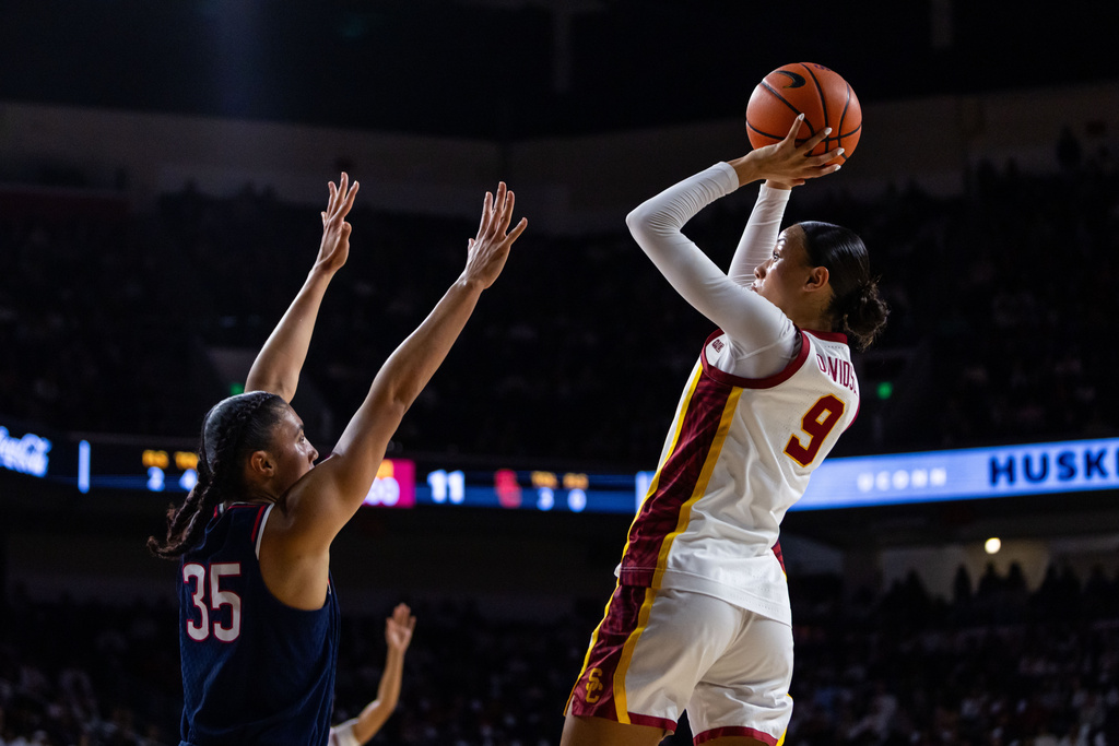 Southern California guard Jazzy Davidson (9) shoots against UConn guard Azzi Fudd (35) during the first half of an NCAA college basketball game Saturday, Dec. 13, 2025, in Los Angeles. (AP Photo/Ethan Swope)