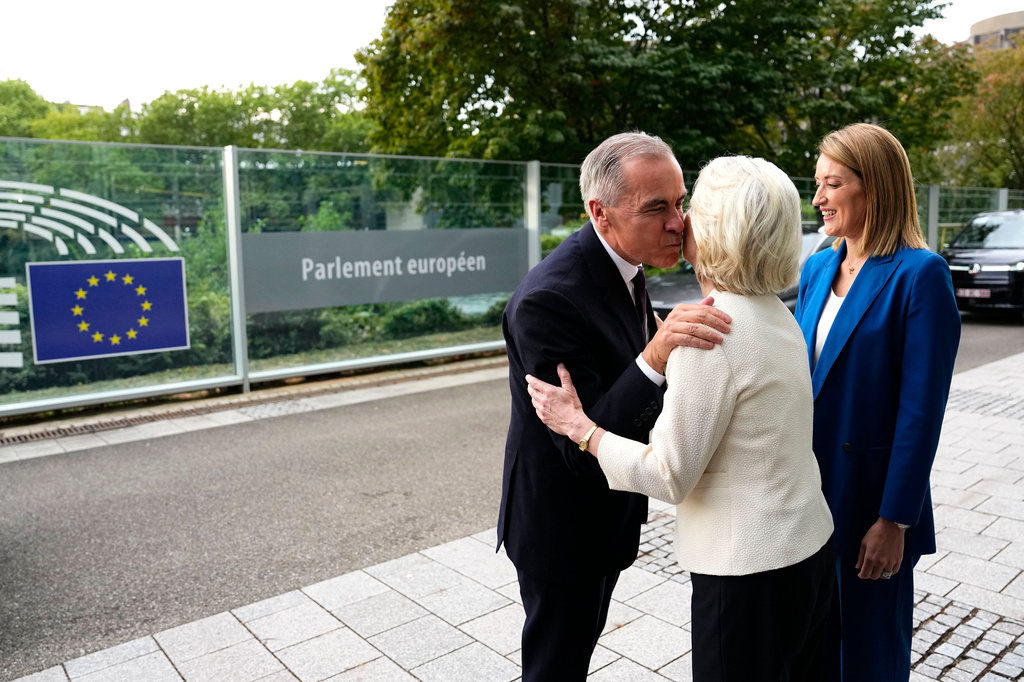 Canadian Prime Minister Mark Carney greets European Commission President Ursula von der Leyen as President of the European Parliament Roberta Metsola, right, looks on, as he arrives at the European Parliament in Strasbourg, France, Wednesday, Sept. 16, 2026. (Justin Tang/The Canadian Press via AP)