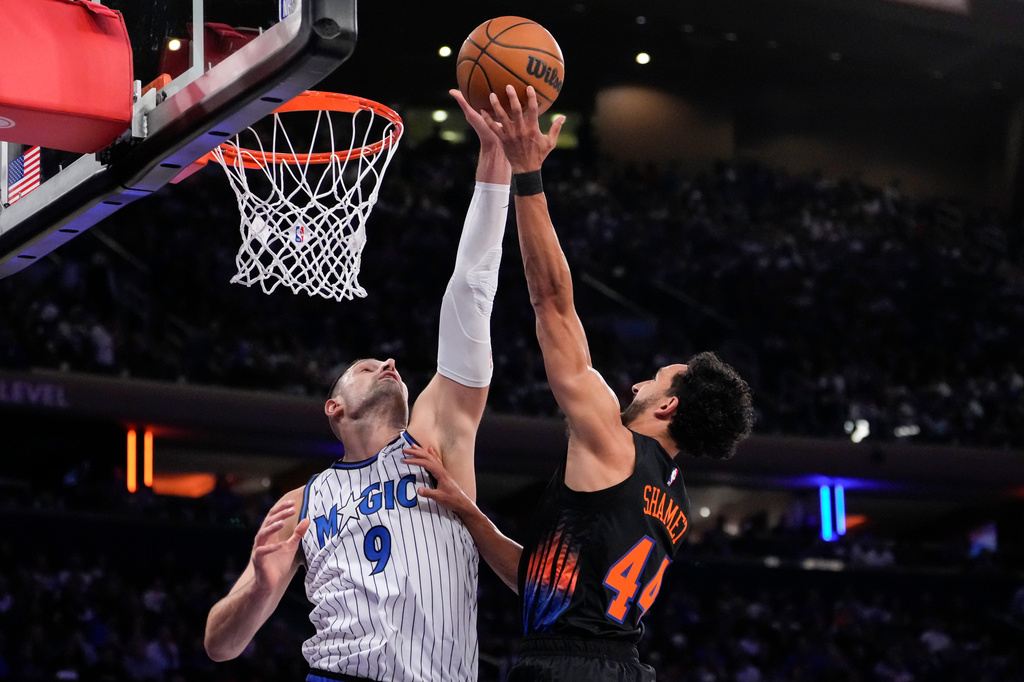 Orlando Magic center Nikola Vucevic (9) blocks New York Knicks guard Landry Shamet (44) during the first half of an NBA basketball game, Sunday, Oct. 25, 2026, in New York. (AP Photo/Yuki Iwamura)