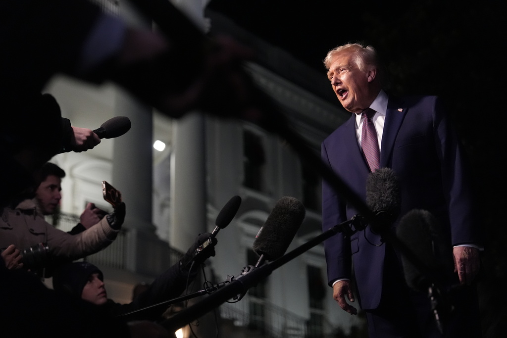 FILE - President Donald Trump talks to the media as he walks to Marine One from the White House, Friday, Dec. 19, 2025, in Washington. (AP Photo/Julia Demaree Nikhinson, File)