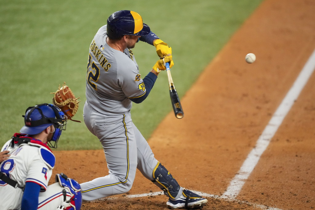 Milwaukee Brewers' Rhys Hoskins swings at a pitch during a pinch hit at bat against the Texas Rangers during the sixth inning of a baseball game Tuesday, Sept. 9, 2025, in Arlington, Texas. (AP Photo/Julio Cortez)