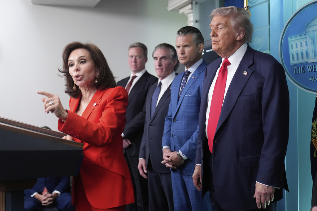 U.S. Attorney Jeanine Pirro speaks with reporters as President Donald Trump, from right, Defense Secretary Pete Hegseth, Interior Secretary Doug Burgum and Army Secretary Dan Driscoll listen in the James Brady Press Briefing Room at the White House, Monday, Aug. 11, 2025, in Washington. (AP Photo/Mark Schiefelbein)