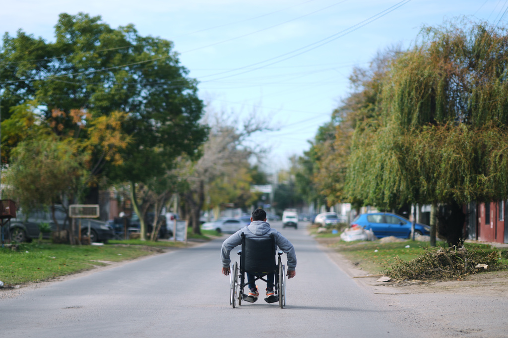 Ivan Ferreiro rides down the street in his wheelchair in Moreno, on the outskirts of Buenos Aires, Argentina Wednesday, May 13, 2026. (AP Photo/Natacha Pisarenko)