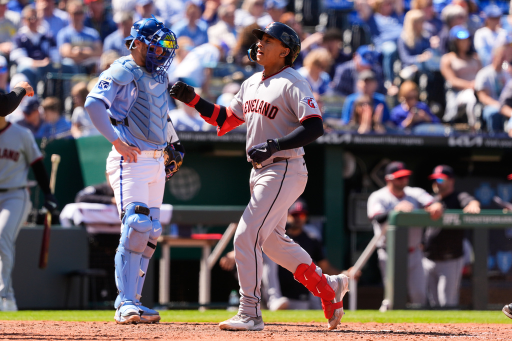 Cleveland Guardians' Bo Naylor crosses the plate past Kansas City Royals catcher Carter Jensen after hitting a three-run home run during the seventh inning of a baseball game Thursday, May 7, 2026, in Kansas City, Mo. (AP Photo/Charlie Riedel)