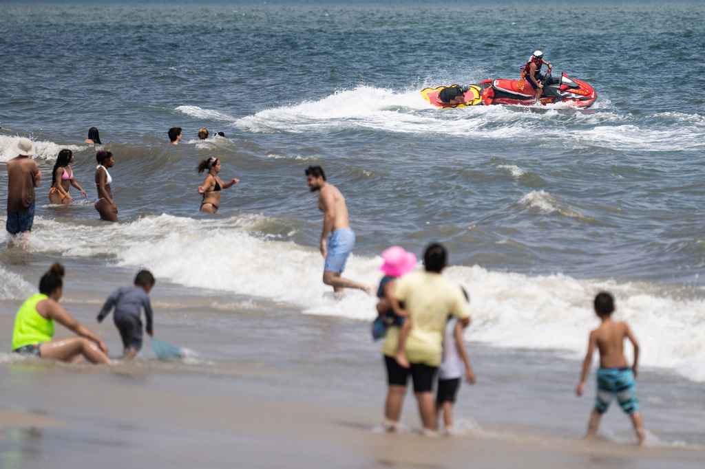 FILE - Lifeguards ride a jet ski during a shark patrol run at Jones Beach State Park, Thursday, July 6, 2023, in Wantagh, N.Y. (AP Photo/John Minchillo,File)