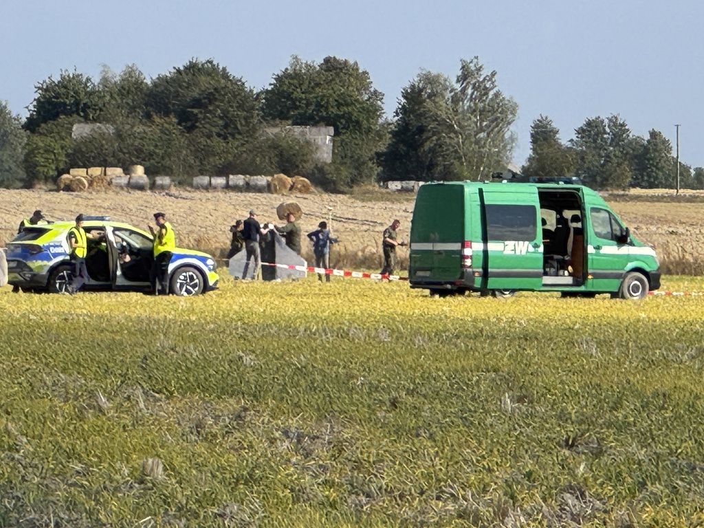 Police and Military Police secure parts of a damaged UAV shot down by Polish authorities at a site in Wohyn, Poland, Wednesday, Sept. 10, 2025.(AP Photo/Rafal Niedzielski)