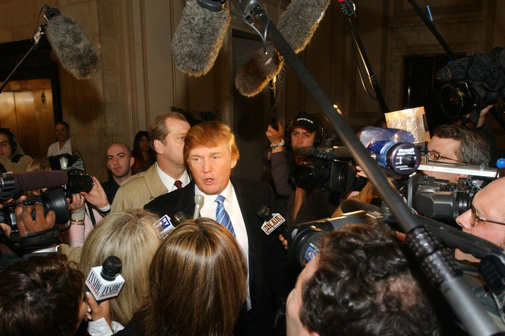 FILE - Donald Trump is greeted by the media after arriving at open auditions for the second season for his reality television show, "The Apprentice," on March 18, 2004, in New York. (AP Photo/Frank Franklin II, File)