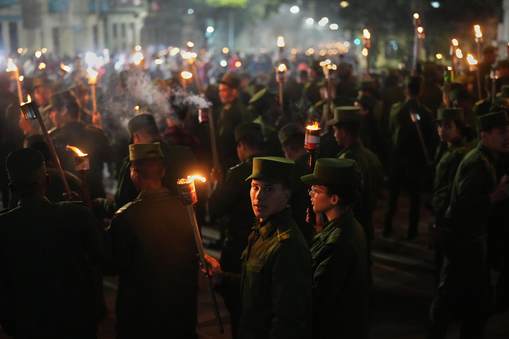 Soldiers march with torches to mark the 173rd anniversary of the birth of national independence hero Jose Marti, in Havana, Tuesday, Jan. 27, 2026. (AP Photo/Ramon Espinosa)