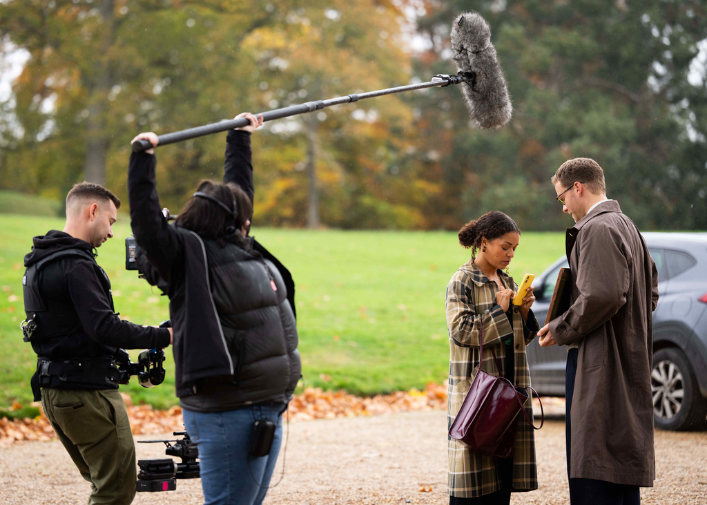 Antonia Thomas, second right, and and Josh Dylan, right appear during the filming of the Agatha Christie series "Tommy & Tuppence" in Beaconsfield, England on Wednesday, Oct. 29, 2025. (Photo by Scott A Garfitt/Invision/AP)