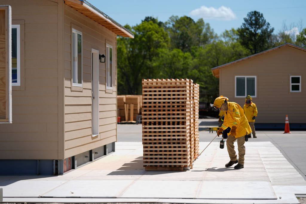 Lead carpenter David Trull ignites wood cribs for an accessory dwelling unit burn experiment at the Institute for Business & Home Safety center Wednesday, April 1, 2026, in Richburg, S.C. (AP Photo/Erik Verduzco)