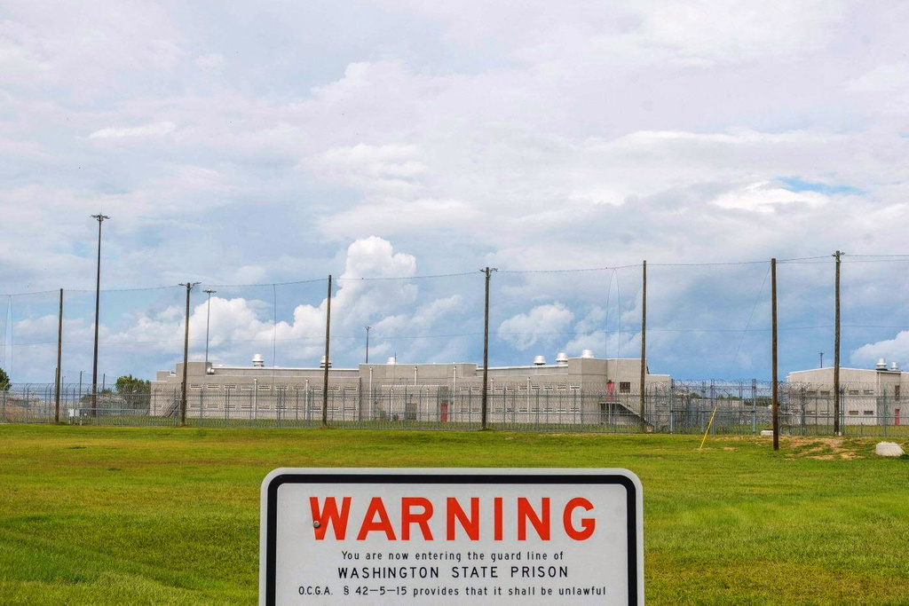 A warning sign is posted outside Washington State Prison in Davisboro, Ga., Friday Aug. 12, 2022. (Grant Blankenship/Georgia Public Broadcasting via AP)