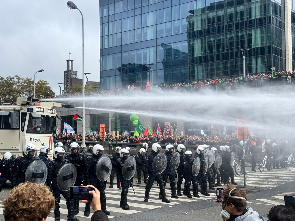 Police use a water cannon against protestors during a demonstration and general strike in Brussels, Tuesday, Oct. 14, 2025. (AP Photo/Sylvain Plazy)