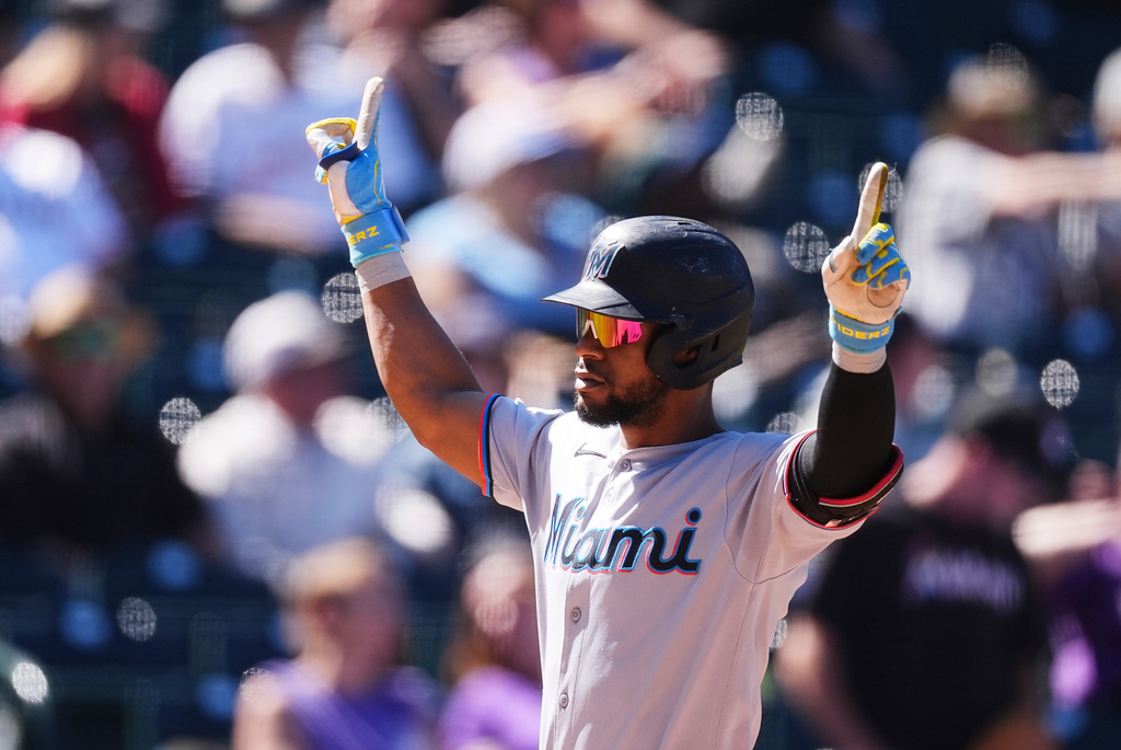 Miami Marlins' Otto Lopez gestures as he crosses home plate after hitting a solo home run off Colorado Rockies starting pitcher Tanner Gordon in the third inning of a baseball game Thursday, Sept. 18, 2025, in Denver. (AP Photo/David Zalubowski)