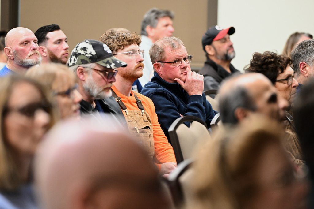 People listen during an East Vincent Township supervisors meeting where an agenda item involved a data center proposal at the former Pennhurst state hospital grounds, Dec. 17, 2025, in Spring City, Pa. (AP Photo/Marc Levy)