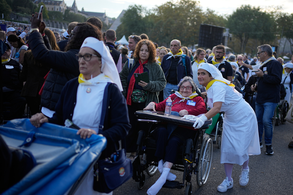 Pilgrims arrive for a Mass celebrated by Pope Leo XIV at the Sanctuary of Our Lady of Lourdes, France Sunday, Sept. 27, 2026. (AP Photo/Laurent Cipriani)